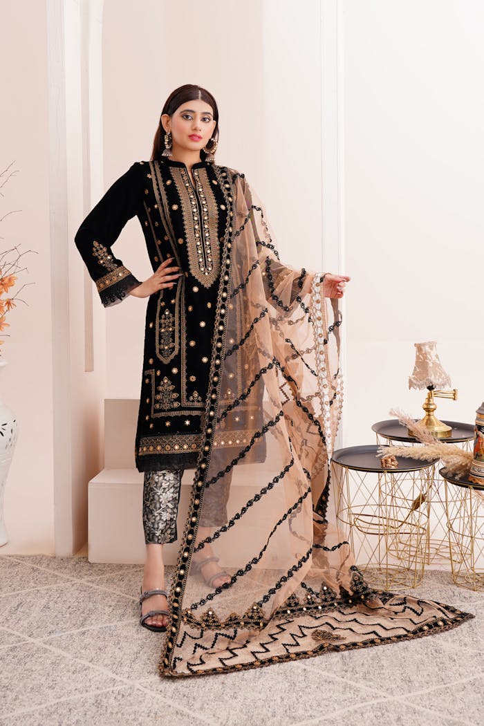 Stylish eastern fashion model in decorated attire, posing indoors in Lahore.